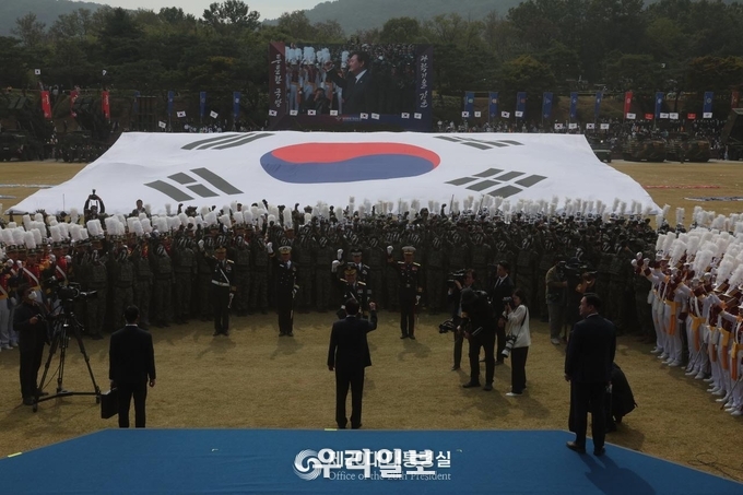 국군 장병들이 군가를 부르면서 사열대 앞으로 제대를 구성했고, 힘찬 함성과 함께 육·해·공군, 해병대기와 대형 태극기를 펼쳤다. 이어 윤석열 대통령은 단상으로 내려가 장병들과 함께 ‘국군의 사명’ 구호를 힘차게 외치며 조국을 수호하겠다는 결의를 다졌다.ⓒ 대통령실 제공