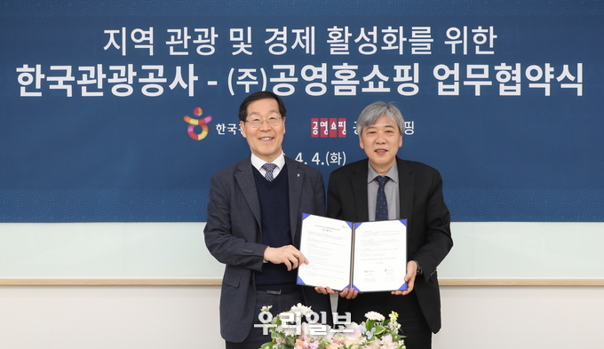 한국관광공사 김장실 사장(왼쪽)과 (주)공영홈쇼핑 조성호 대표이사(오른쪽)가 업무협약서를 들고 기념촬영을 하고 있다.(사진=한국관광공사)
