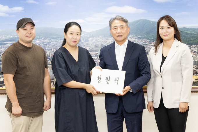 신지수 인천시계양구의원이 계양맘카페 회원들과 어린이 물놀이터 조성 지역주민 청원서를 윤환 계양구청장에게 전달하고 있다. ⓒ 계양구의회 제공