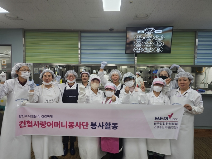 한국건강관리협회 인천시지부가 미추홀노인복지관에서 지역주민 어르신 및 독거노인 200여 명을 대상으로 배식 및 설거지 봉사활동을 진행하고 기념촬영을 하고 있다.ⓒ한국건강관리협회 인천시지부 제공