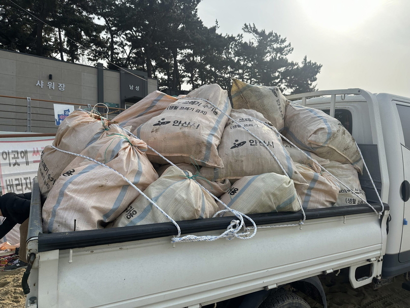 안산시 대부해양본부 직원들이 수거한 쓰레기를 트럭에 싣고 있다.ⓒ안산시