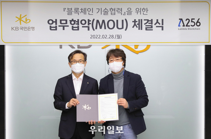 지난 28일 KB국민은행 IT센터에서 열린 '블록체인 기술협력'을 위한 업무협약(MOU) 체결식에서 (왼쪽)윤진수 KB국민은행 테크그룹 대표와 (오른쪽)박재현 람다256 대표이사가 기념촬영을 하고 있다. 