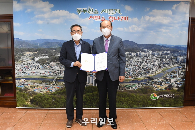 박형덕 동두천시장이 도시계획위원회 위촉식에서 최주영 교수에게 위촉장을 전달하고 기념촬영을 하고 있다. ⓒ 동두천시청 제공