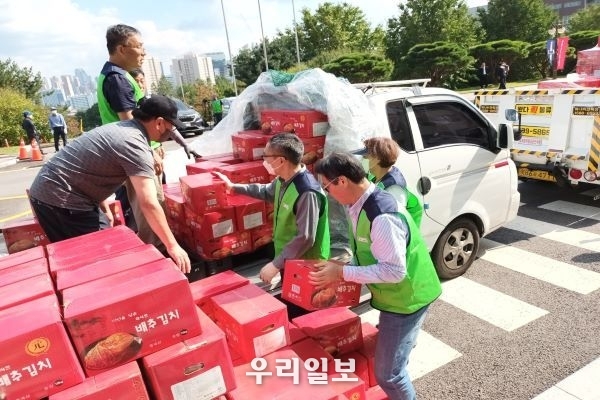 지난 10월 5일 오후 사단법인 주거복지연대 경기남부지사장 이석훈(앞쪽)이 사랑의 김치 나눔 봉사를 위해 평택물류단지에서 10kg 김치 박스를 나르고 있다.